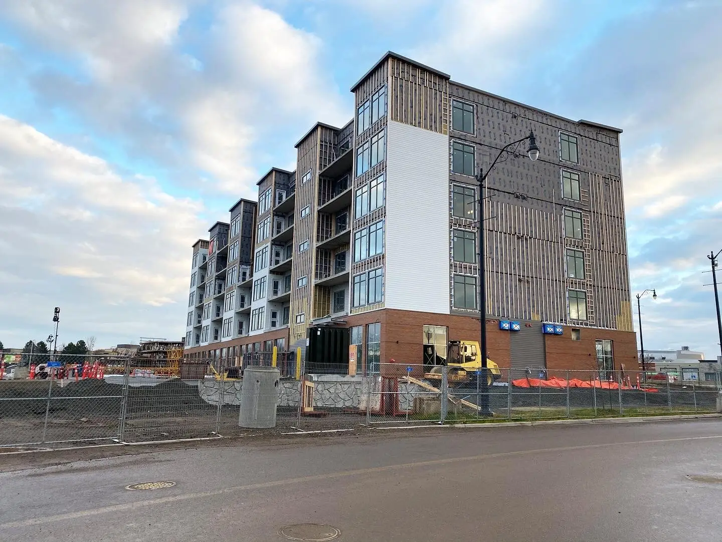 A multi-storey residential building under construction in Greater Moncton, hoarding still up