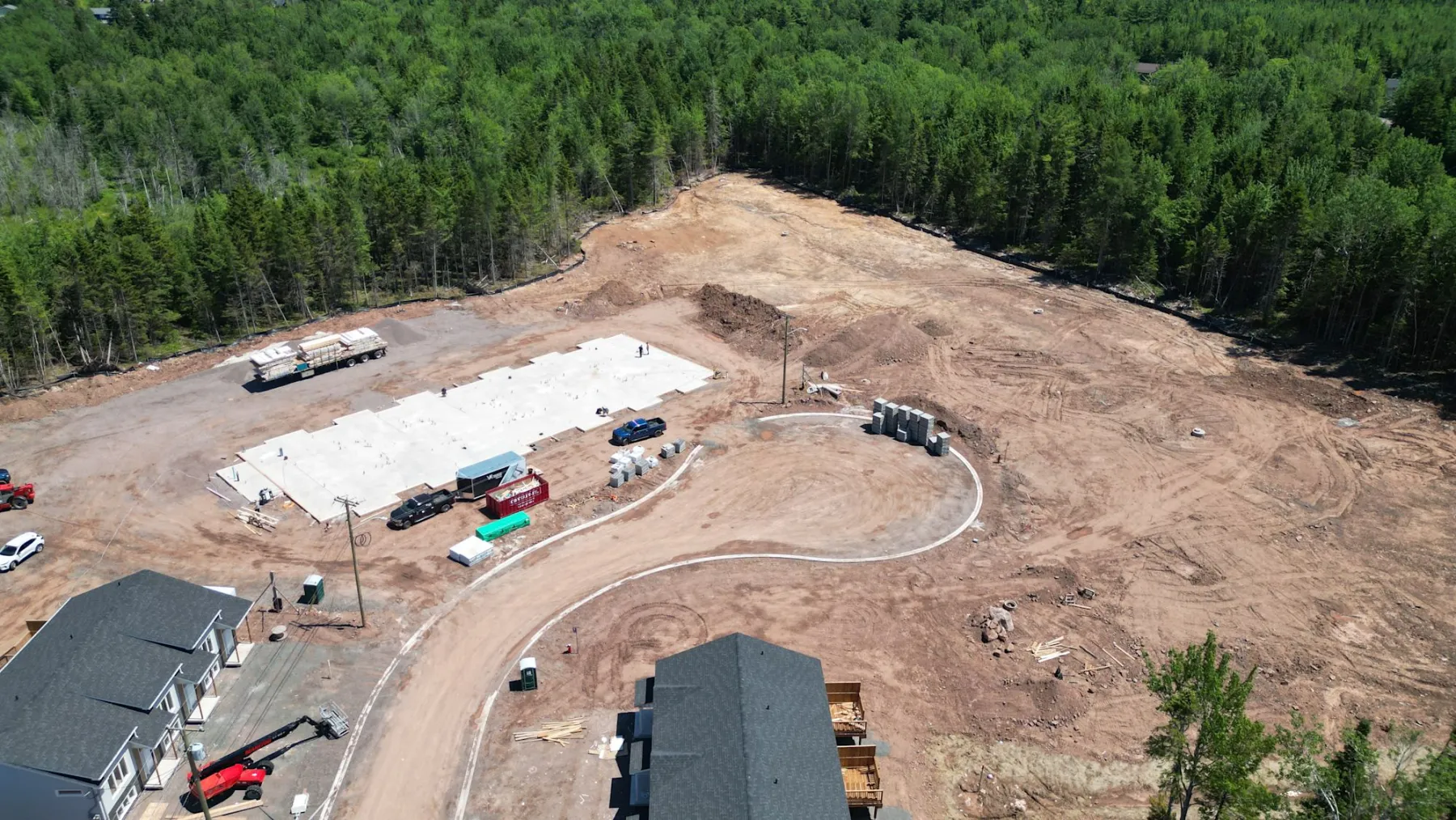 The building slab poured, with the site graded around it