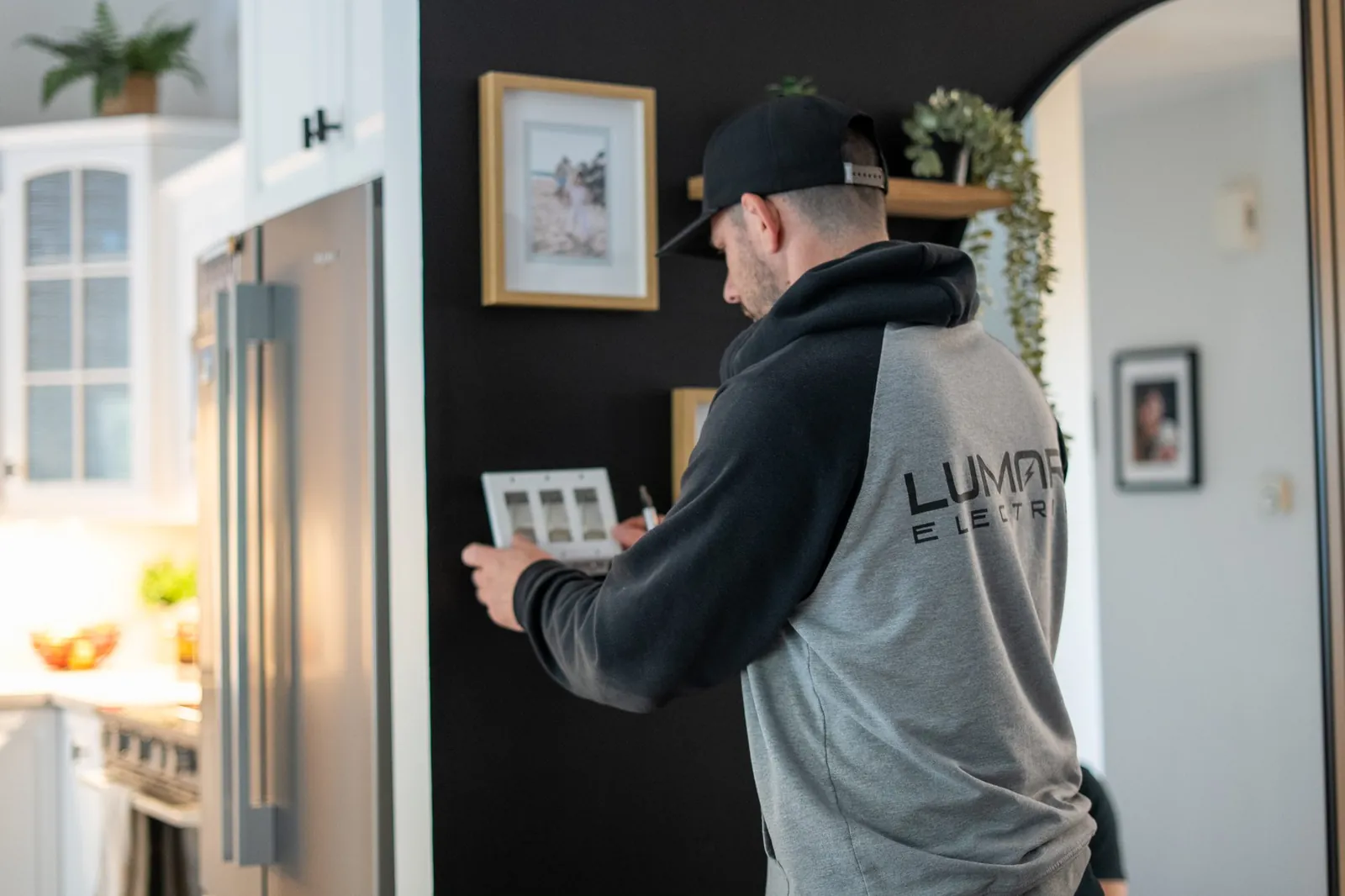 Electrician installing a wall switch during a residential service call