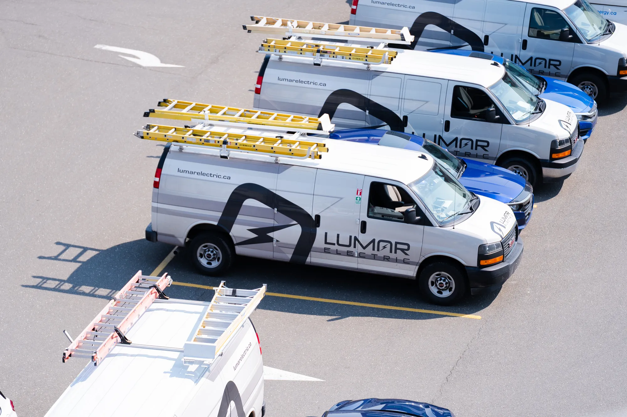 An aerial view of the LuMar Electric van fleet lined up before the day&rsquo;s work