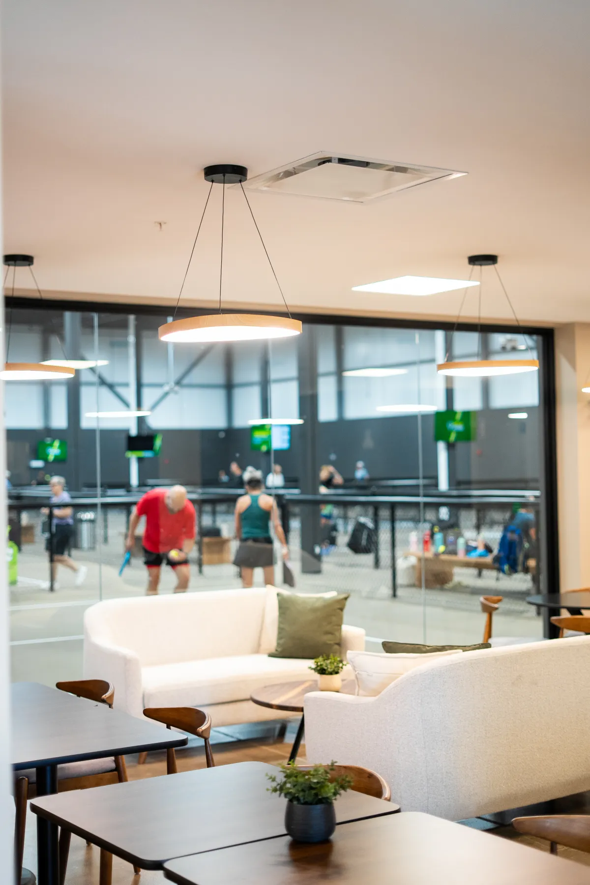 The Rally House lounge, with the courts visible through the glass