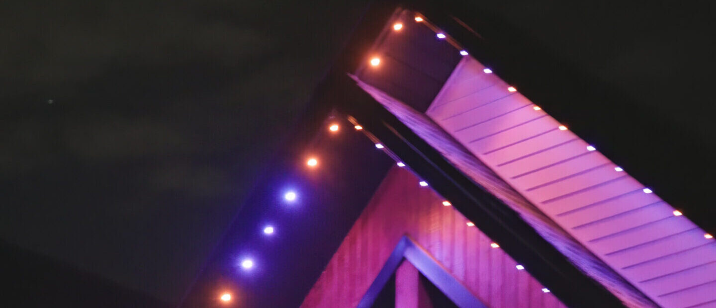 Home lit with purple and orange permanent LED outdoor lighting