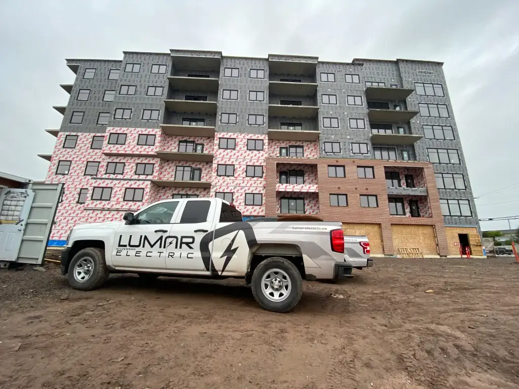 Construction site with truck and building in progress.