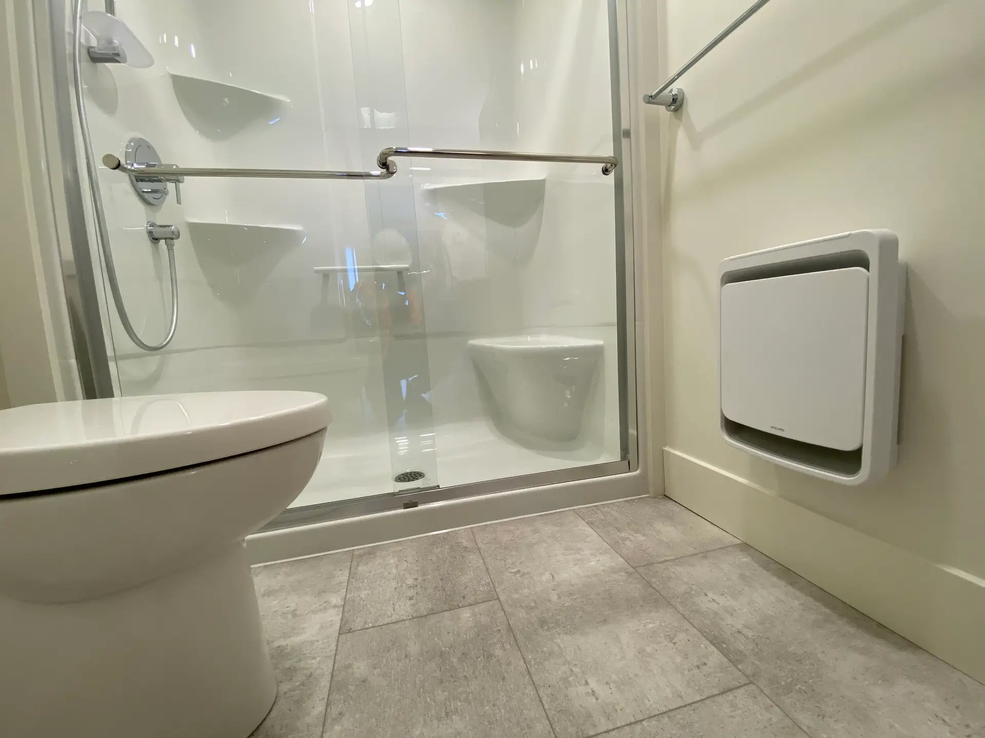 Modern bathroom with shower and toilet.