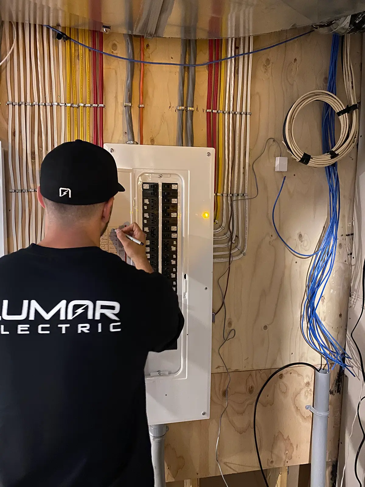 Electrician working on circuit breaker panel